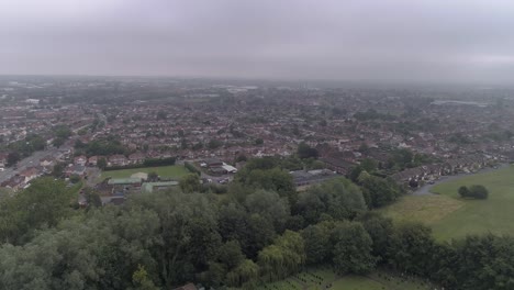 Cloudy-aerial-shot-over-Cricklade-in-Swindon,-Wiltshire