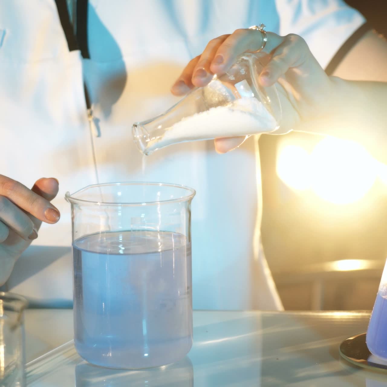 Young woman working in laboratory on experiments. Testing chemicals in laboratory