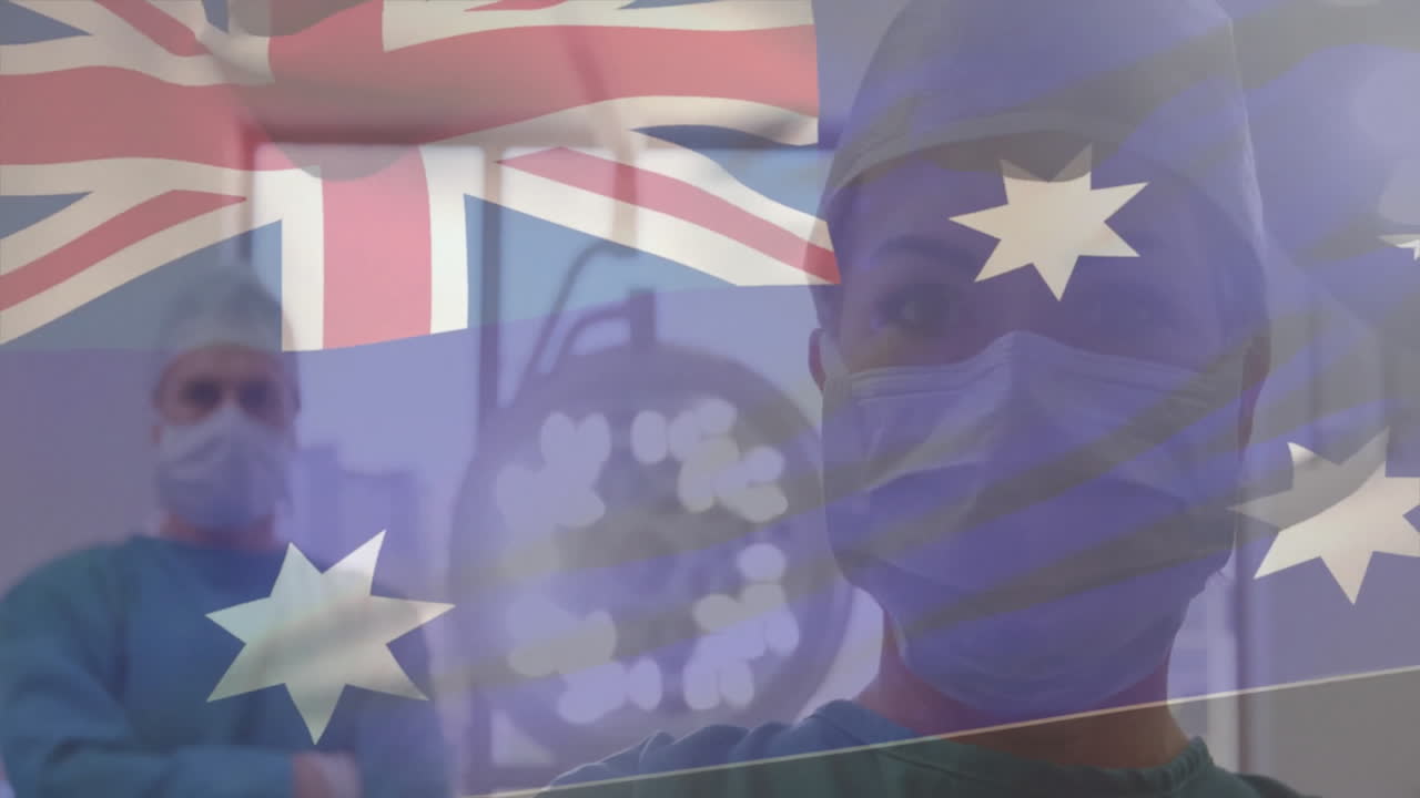 Animation of flag of australia over caucasian surgeons with face masks