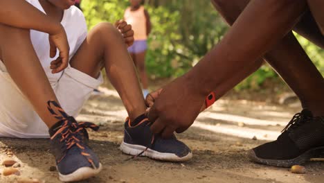 close up of father is doing his son shoelaces