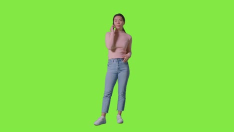 Full-Length-Studio-Shot-Of-Woman-Talking-On-Mobile-Phone-Against-Green-Screen