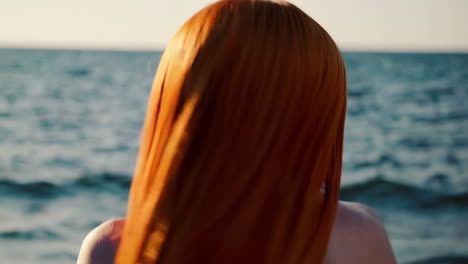 woman with red hair on the beach