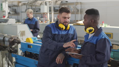 plant workers using tablet in workplace