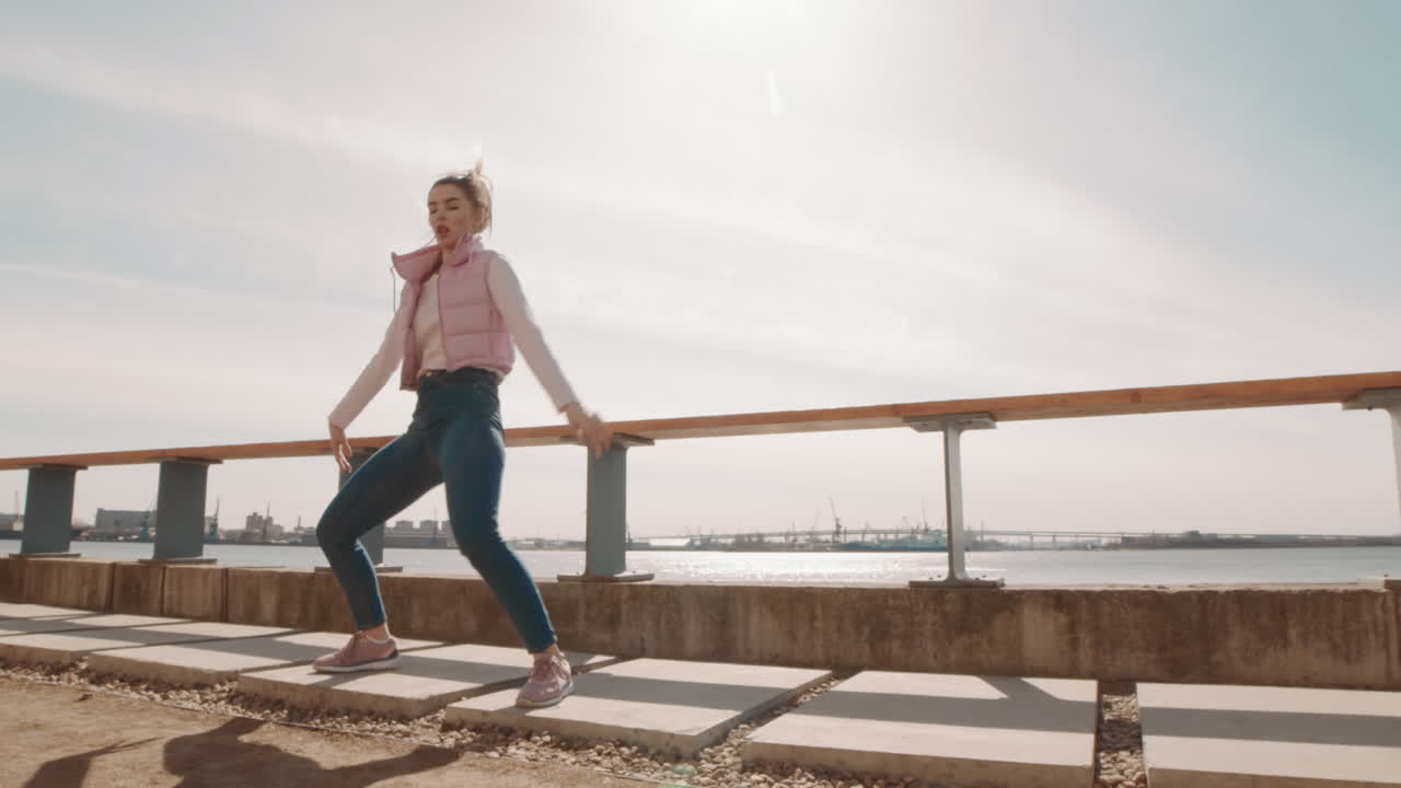 Young Woman Dancing by Fencing