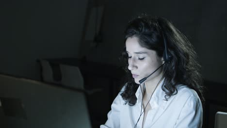 Female-teleworker-in-headset-using-computer