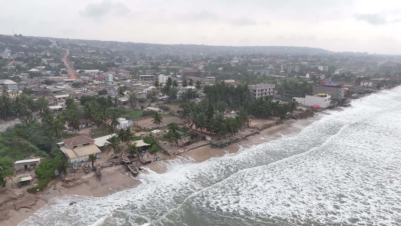 Drönarvy över vita vågor som slår in på stranden vid Accra Beach, Ghana. Filmatisk högvinkelvy över Västafrikas kustlinje och tropiskt strandlandskap.