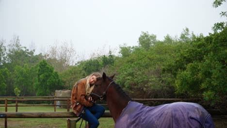 Woman-hugging-horse-on-wooden-fence-4k