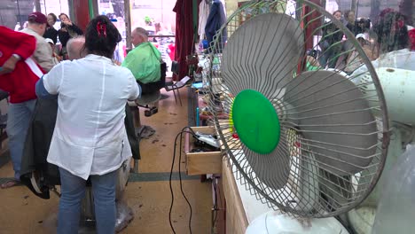 Customers-get-a-haircut-in-a-barber-shop-in-havana-Cuba