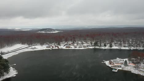 foggy winter lake in snowy woods - drone countryside footage