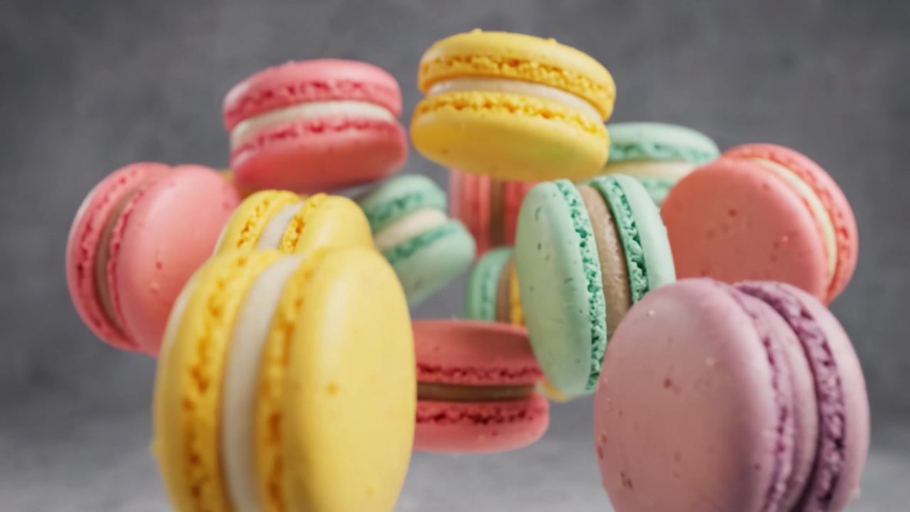 A Vibrant Display of Colorful Macarons in Mid-Air, Showcasing Their Deliciousness and Artistic Presentation in an Eye-Catching Arrangement