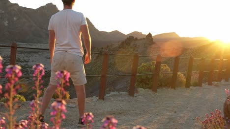 Young-man-jumps-over-guardrail-in-Teide-National-Park,-daredevil