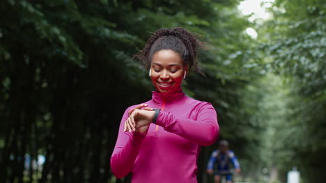 woman checking smartwatch during outdoor workout