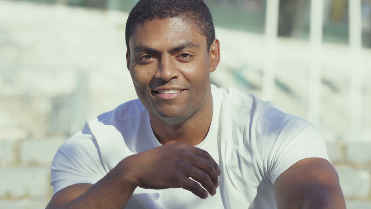 un guapo deportista sonriente mirando a la cámara.