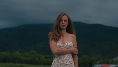 woman in a floral dress in a mountainous landscape
