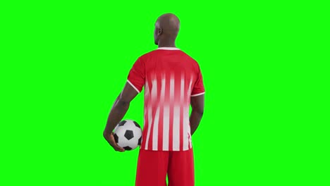 video of african american male soccer player with ball on green screen background