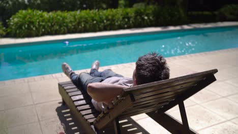 a young boy unwinding beside the pool - close up