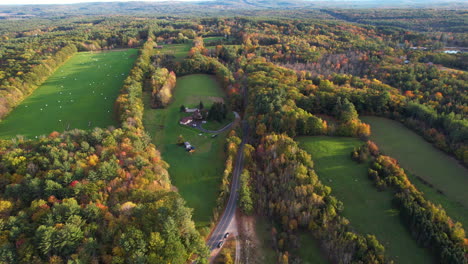 Aerial-View-of-Farming-Fields,-Meadows-and-Colorful-Forest-in-Countryside-Ranch-in-New-Hampshire-USA,-Drone-Shot