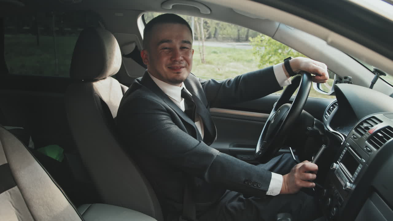 Man Posing in Car with Hand Controls