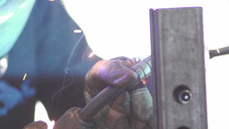 Close-up-footage-of-welding-metal,-showing-protective-gloves-and-sparks-in-high-level-of-detail