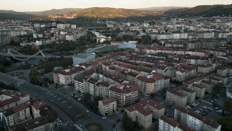aerial sunset view of ourense city, galicia, spain, showing rooftops, river, and urban landscape in golden evening light