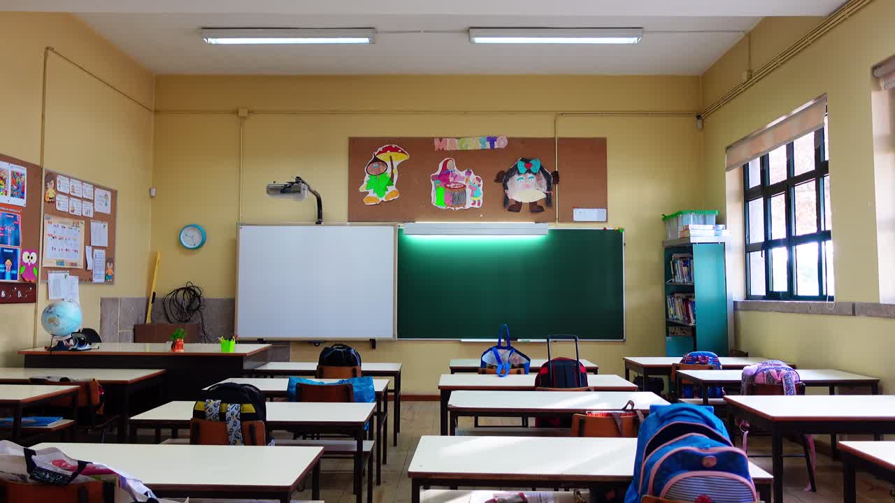 Empty classroom interior with tables and chairs