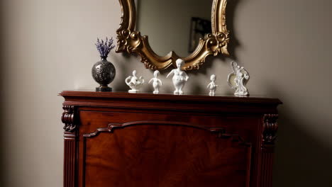 elegant display of porcelain figurines on a vintage dresser with ornate mirror