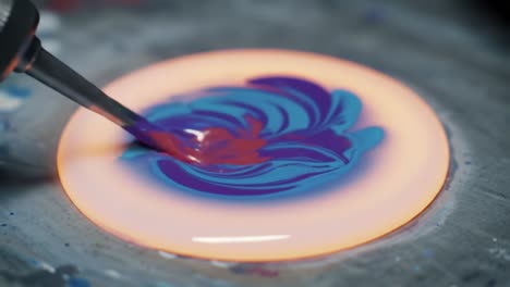 captivating color mixing: a vivid journey through the transformation of paint from solid hue to fluid masterpiece in two stunning frames