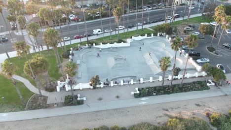 circular aerial number 2 of a skateboard park during sunset with young adults near the beach and busy highway in santa barbara, california, usa