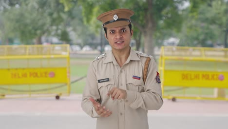 frustrated indian police officer shouting on someone