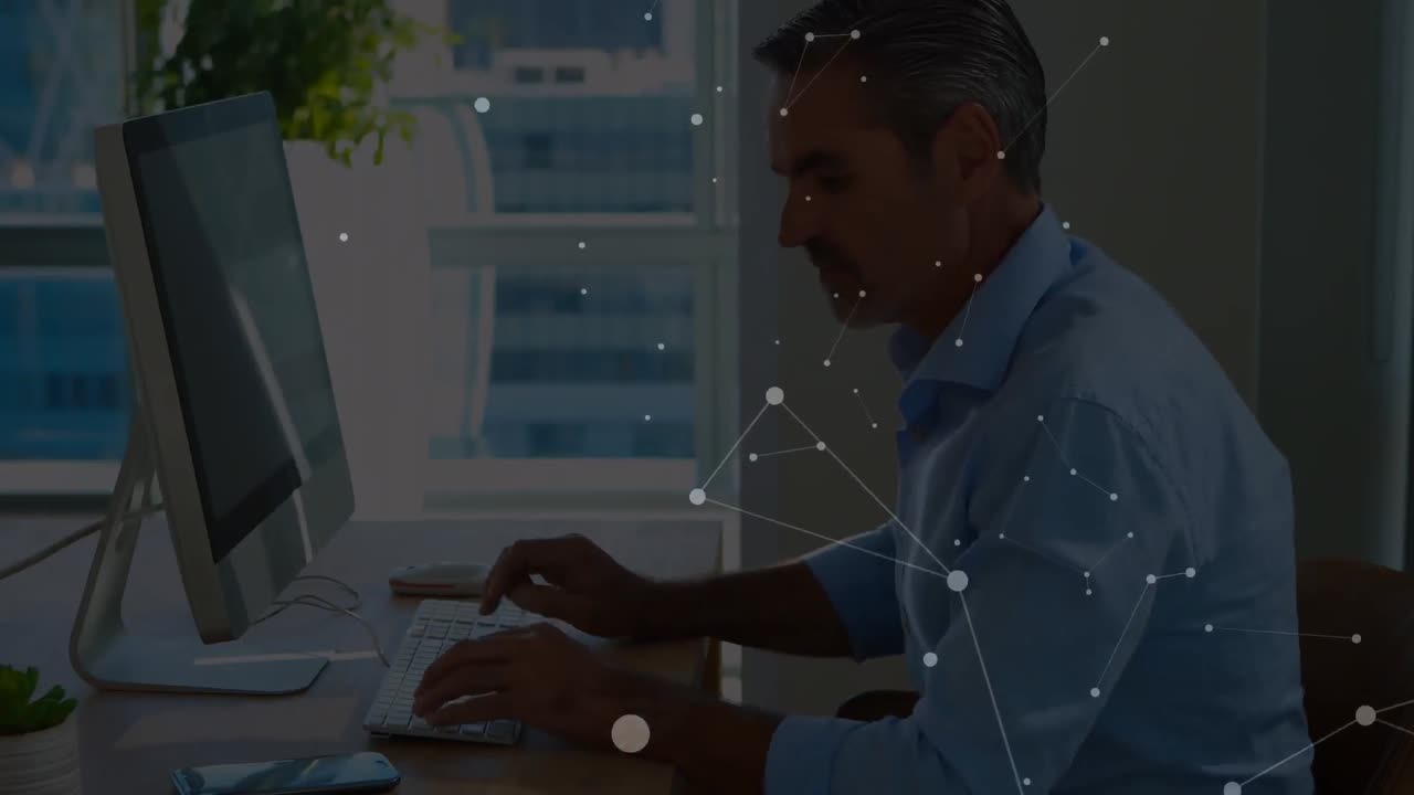 Animation of connected dots on caucasian man talking on cellphone and working on compute