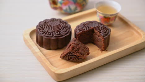 chinese moon cake dark chocolate flavour on wood plate