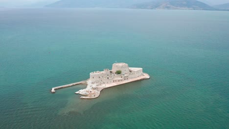 drone shot of fairy tale castle in the middle of the sea, greece