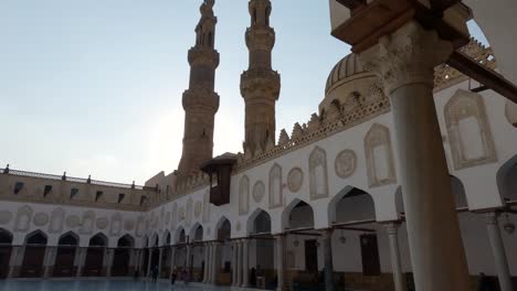 al-azhar mosque, minarets silhouette beautiful archway courtyard, tilt down. cairo