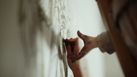 painter hand passing chalk indoors. unknown people enjoying time in art studio.