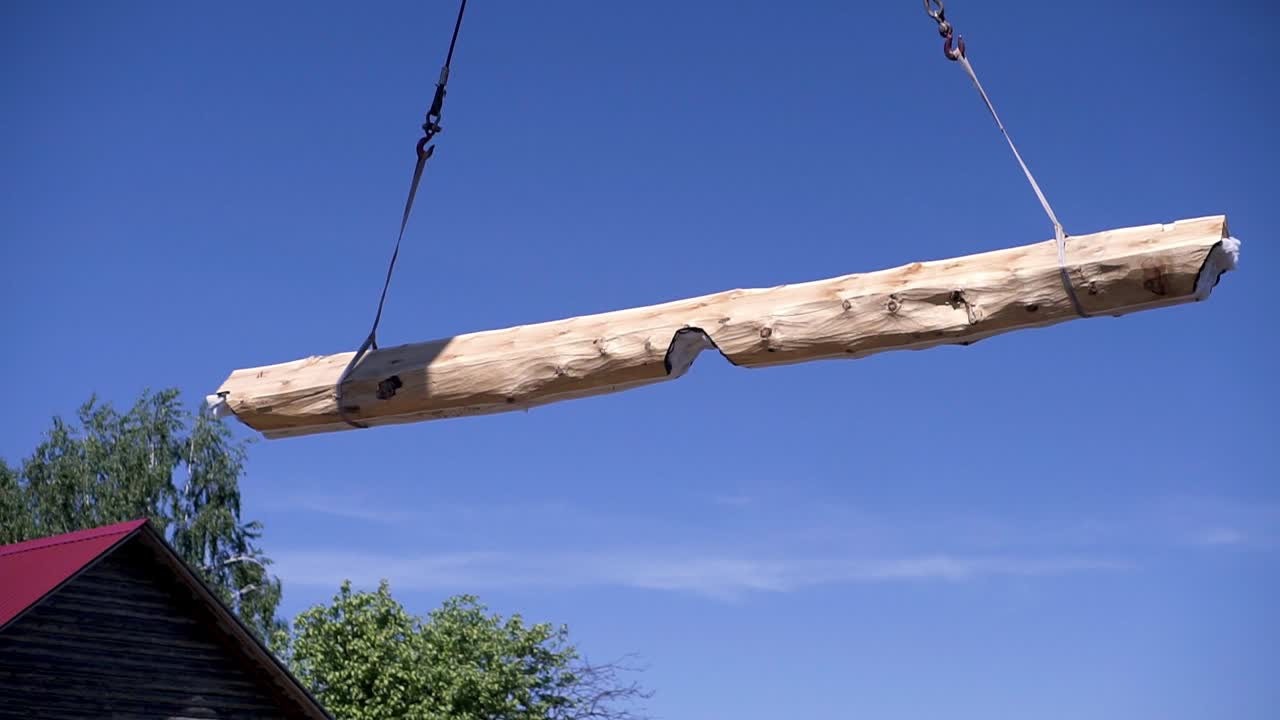 Crane Lifting a Large Wooden Beam