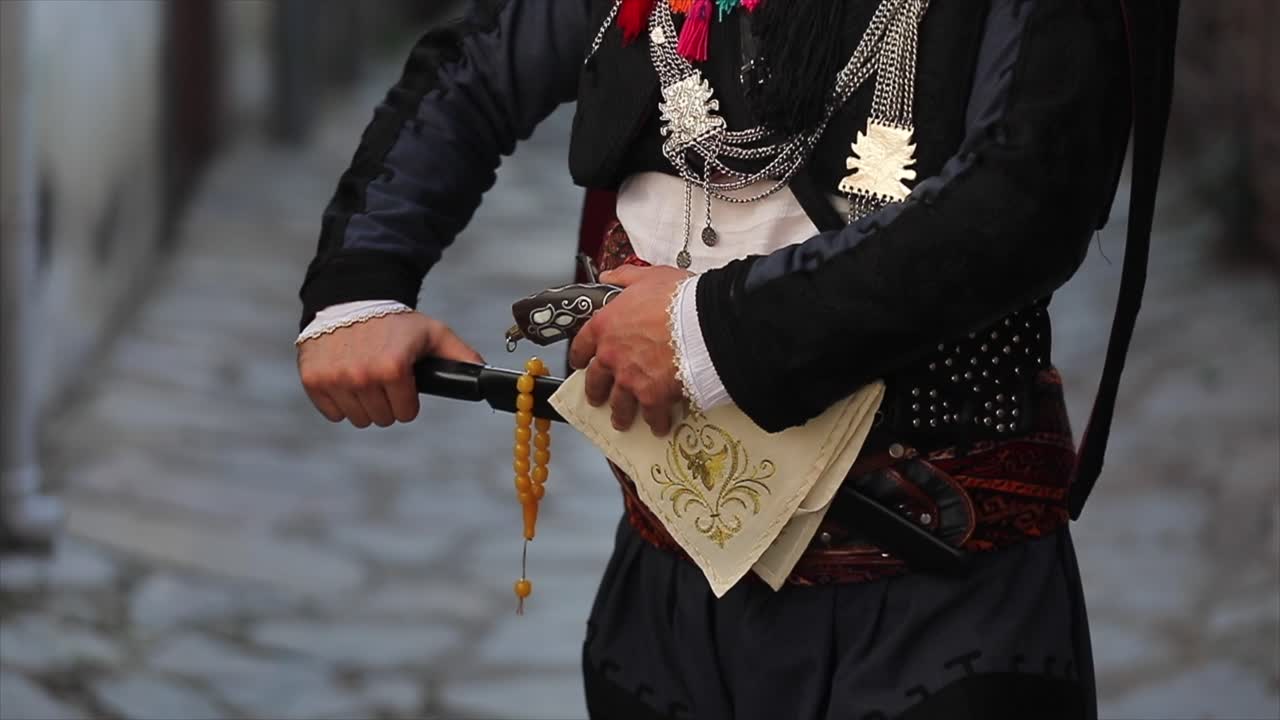 Efe holding her sword with her local clothes