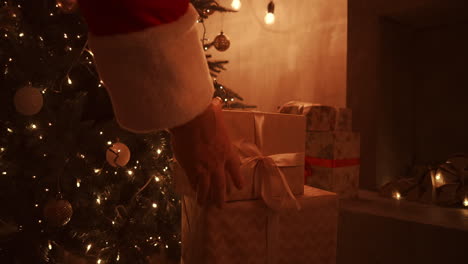 On-Christmas-night-Santa-delivers-gifts-to-homes-while-everyone-is-asleep.-Santa-will-leave-gifts-under-the-Christmas-tree-in-the-decorated-house.-High-quality-4k-footage