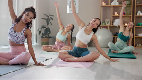 group of women practicing yoga indoors