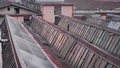 vintage rooftops windows of old factory in milan, handheld view