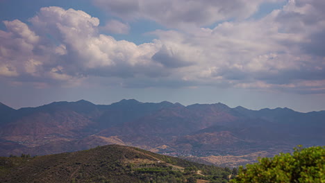 Time-lapse-video-of-clouds-drifting-away-in-the-sky-above-and-cloud-shadows-sliding-over-the-ground---summer-mountain-landscape