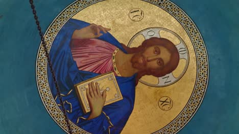 golden ceiling mosaic of jesus christ blessing and holding holy bible