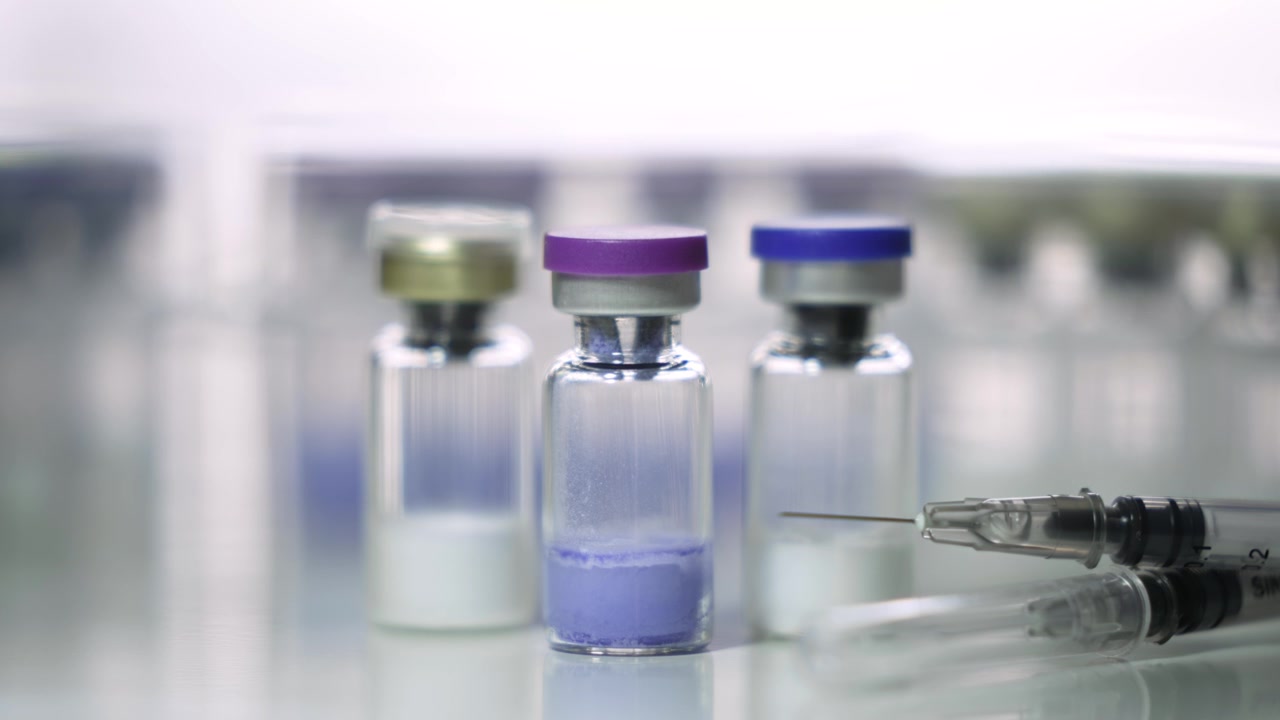 Slow Zoom In on Pharmaceutical Vials and Syringe on Table [Peptide Concept]