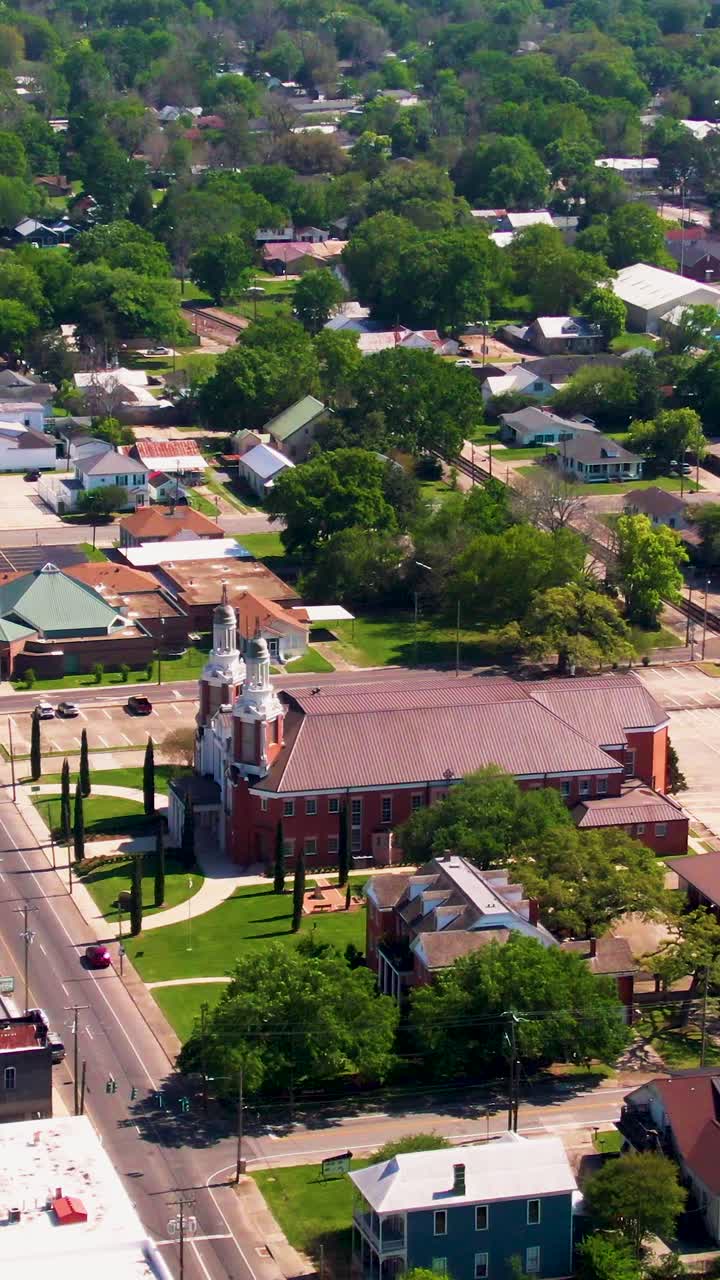 A vertical drone clip focusing on the historic St. Peter Catholic Church in downtown New Iberia, Louisiana. This clip is ideal for tourism, cultural heritage, and establishing shots