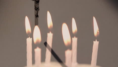 animation of rosary over burning candles on white background