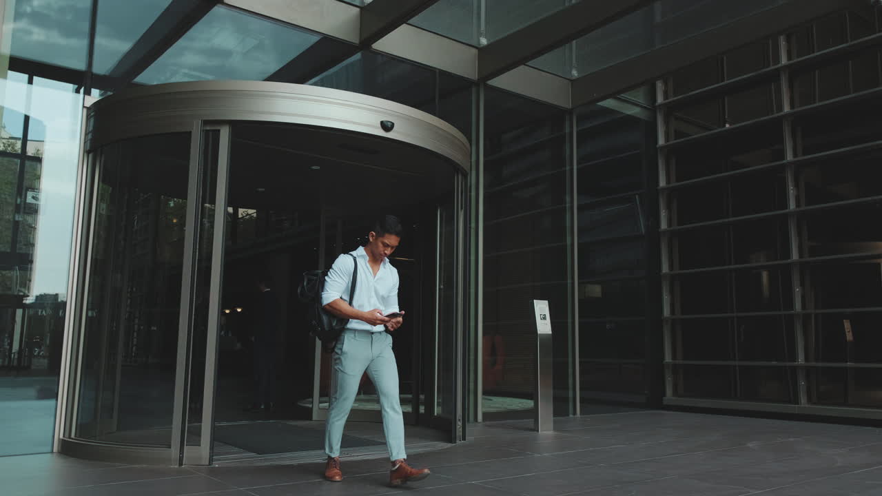 Man walking out of a revolving door