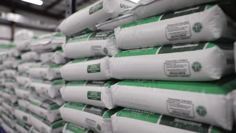 an organized warehouse displaying stacked bags of material, showcasing efficient storage and inventory management in a clean industrial environment