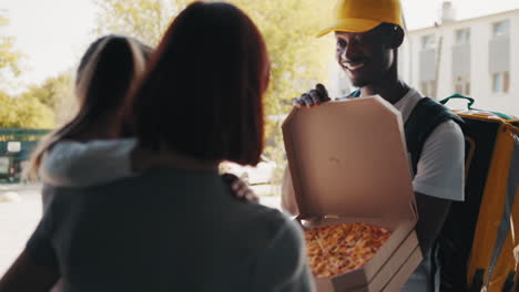 happy family receiving pizza delivery