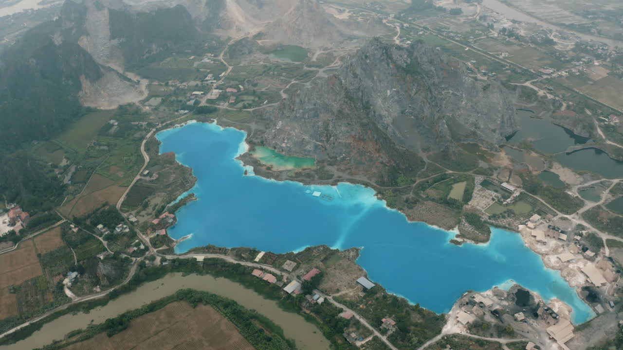 Stunning Aerial View of a Turquoise Lake in a Mountainous Quarry