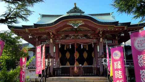 Colorful-Japanese-shrine-entrance-with-pink-banners-and-traditional-architecture