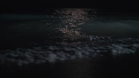 scene of the sea washing shore at night